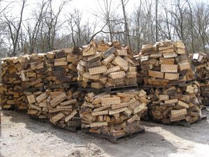 large bundles of firewood on pallets